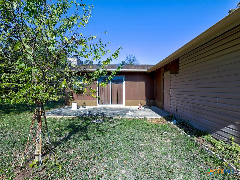 103 Lackey Street Florence, TX 76527 - Photo 6 of 39 a front view of a house with a yard