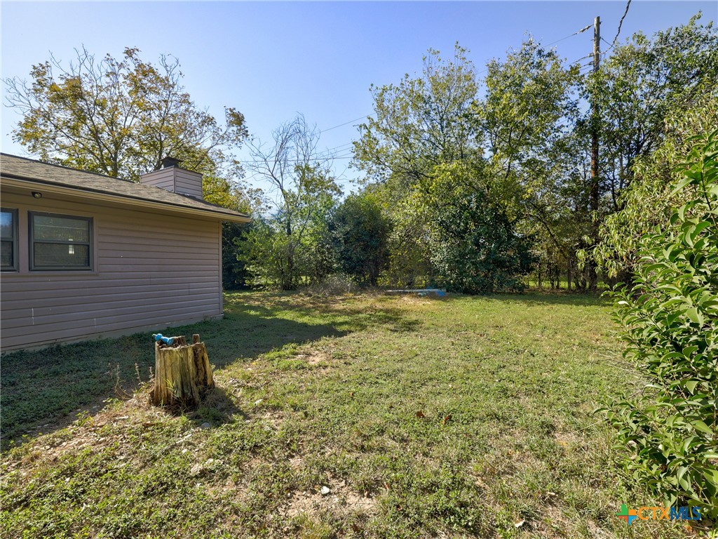 103 Lackey Street Florence, TX 76527 - Photo 10 of 39 a view of a back yard of the house