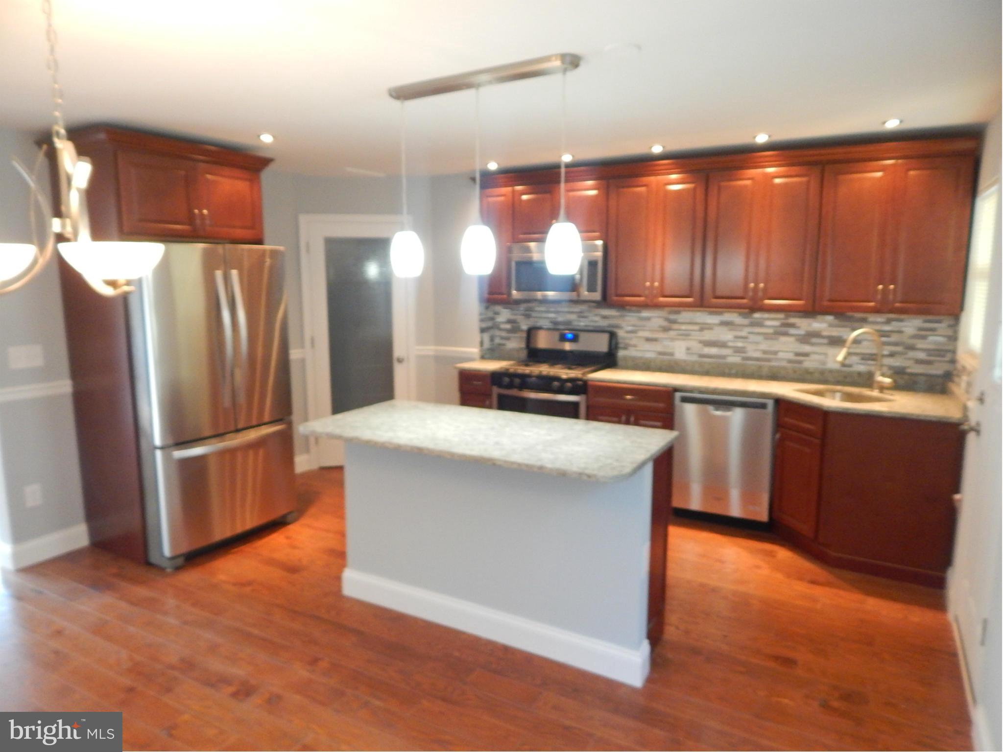 5618 Clearspring Road Baltimore, MD 21212 - Photo 1 of 30 a kitchen with stainless steel appliances granite countertop a stove a refrigerator a sink and a oven