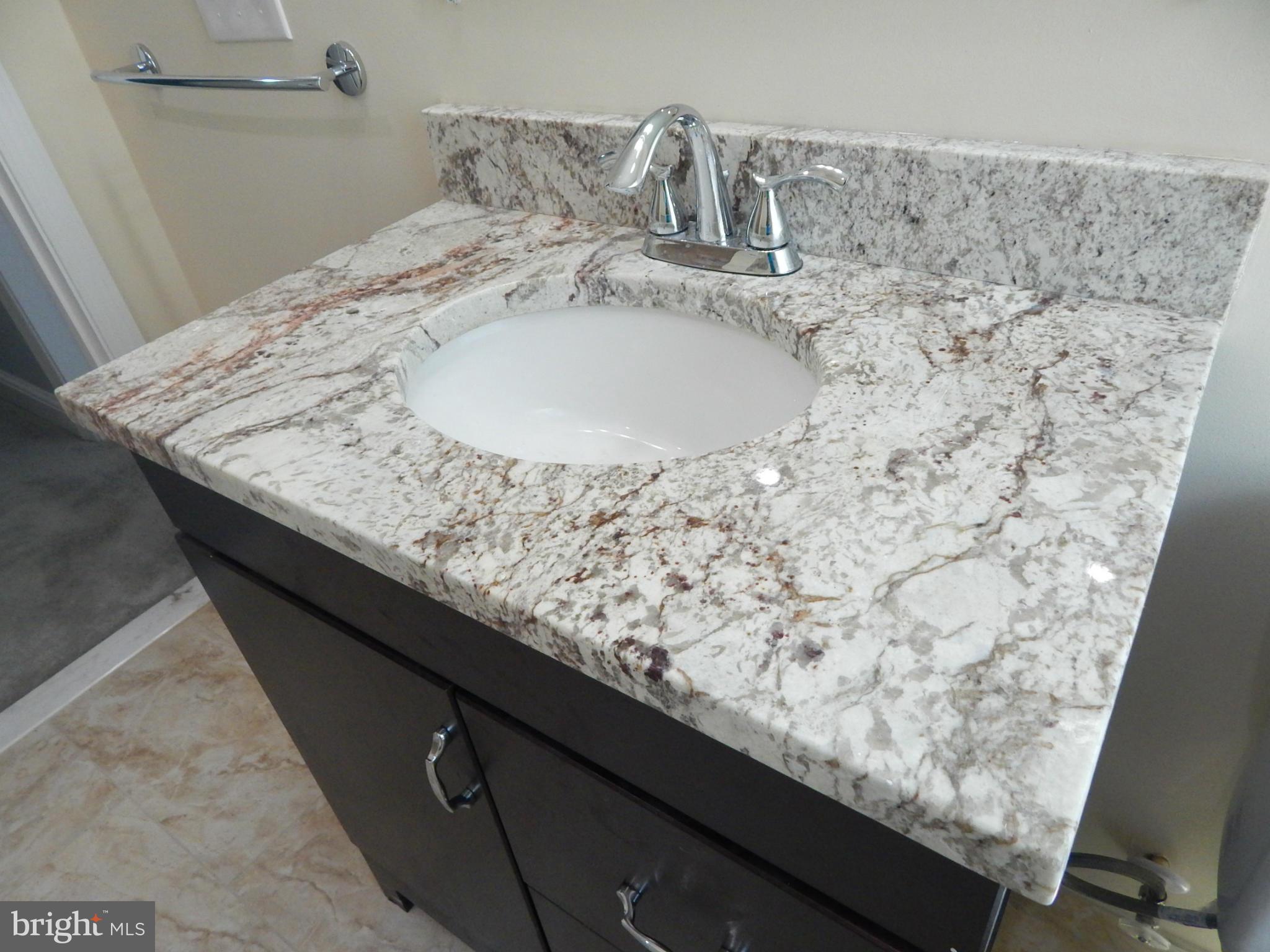 5618 Clearspring Road Baltimore, MD 21212 - Photo 23 of 30 a bathroom with a granite countertop sink and a mirror