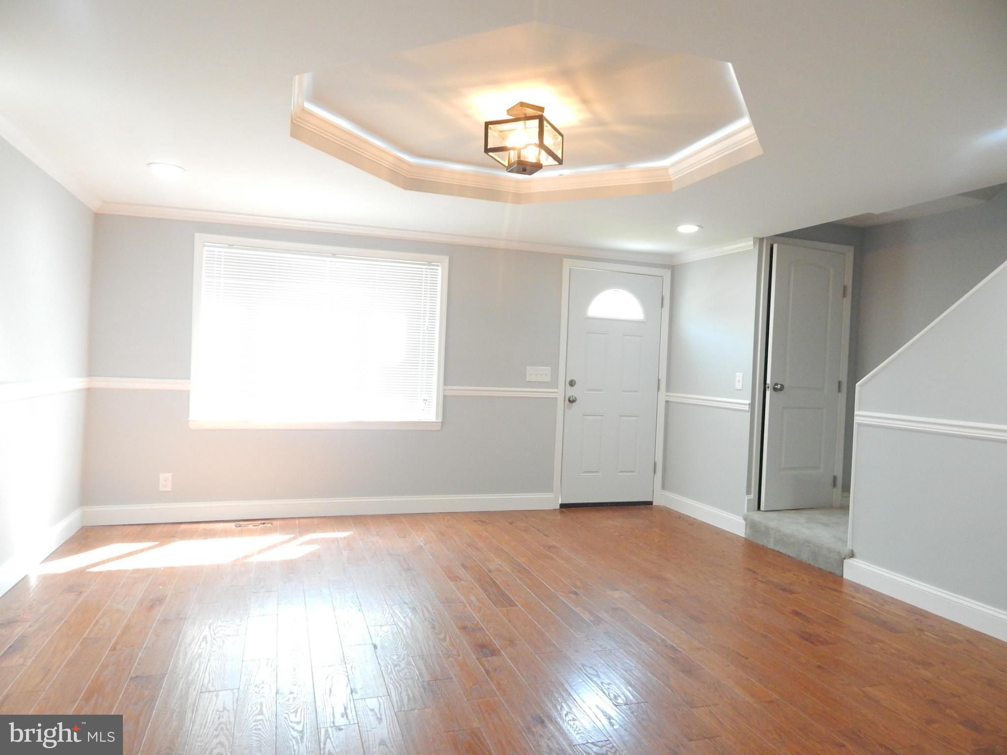 5618 Clearspring Road Baltimore, MD 21212 - Photo 26 of 30 wooden floor in an empty room with a window