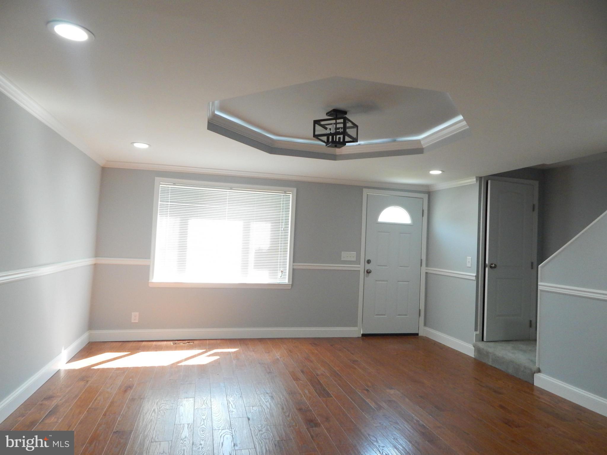 5618 Clearspring Road Baltimore, MD 21212 - Photo 30 of 30 a view of an empty room with wooden floor and a window