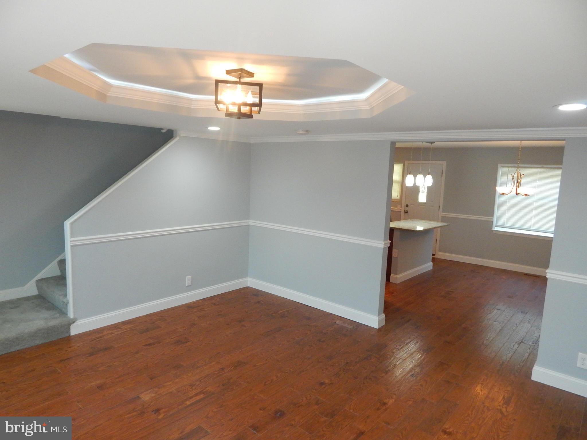 5618 Clearspring Road Baltimore, MD 21212 - Photo 6 of 30 an empty room with wooden floor and windows
