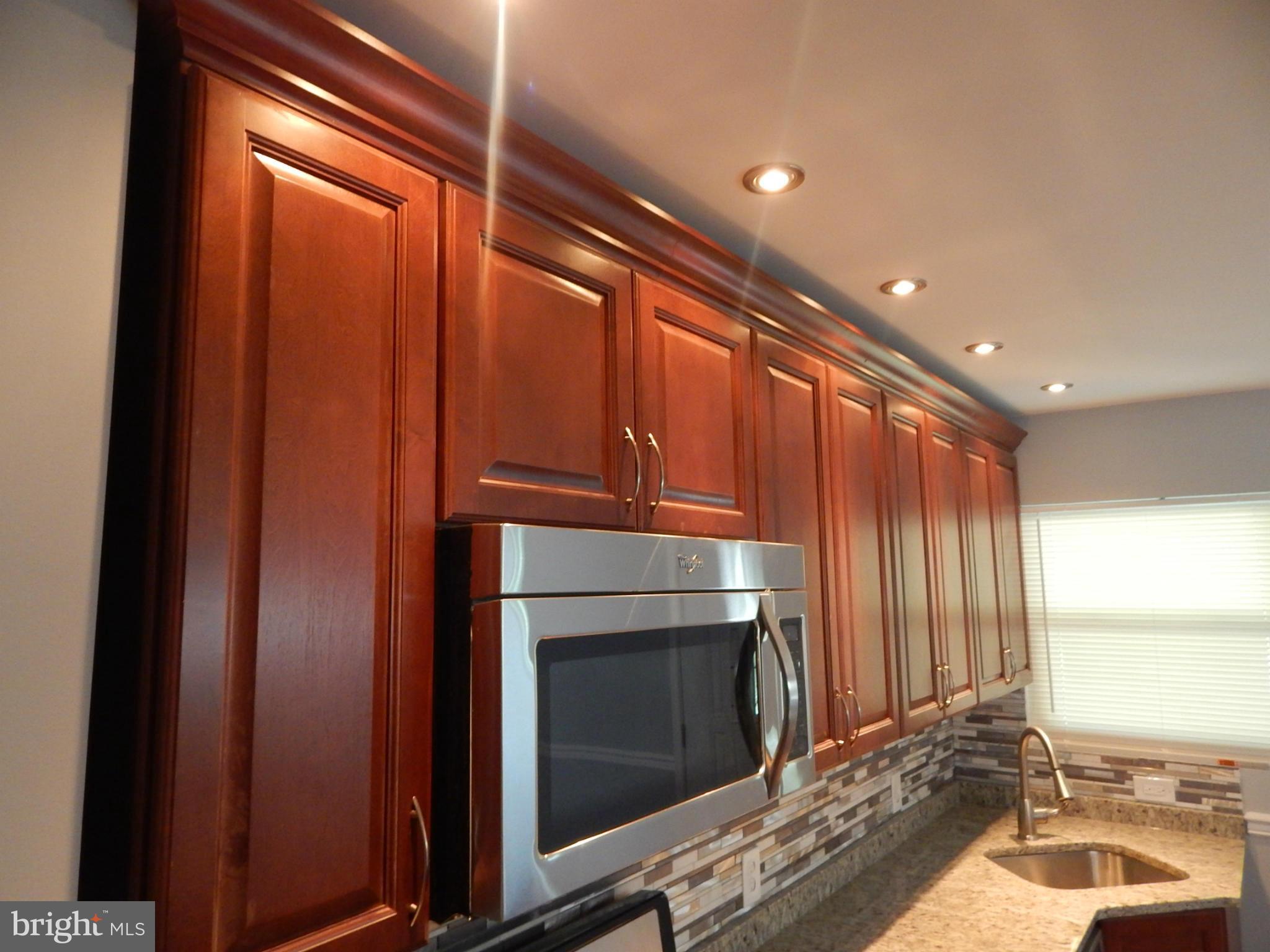 5618 Clearspring Road Baltimore, MD 21212 - Photo 9 of 30 a kitchen with a sink and a refrigerator