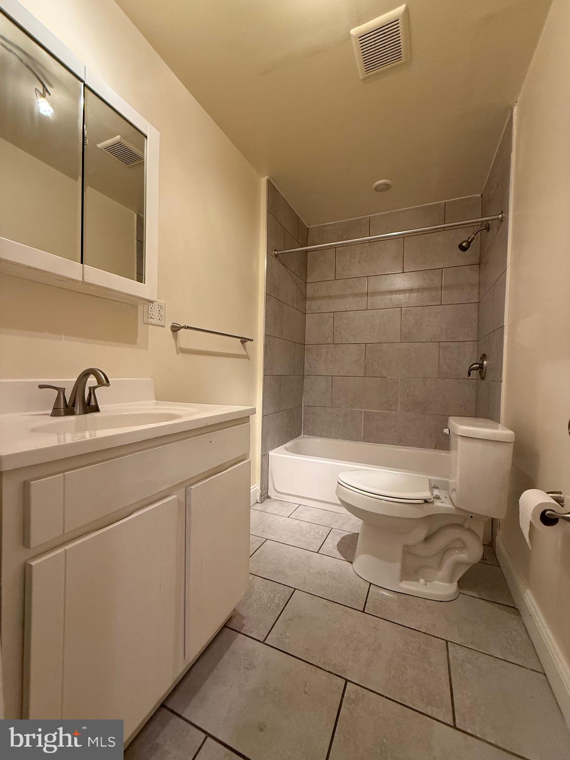 2250 Bryn Mawr Avenue, Unit 1C Philadelphia, PA 19131 - Photo 11 of 12 a bathroom with a sink a toilet and shower