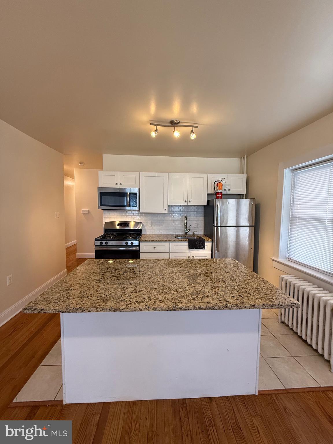 2250 Bryn Mawr Avenue, Unit 1C Philadelphia, PA 19131 - Photo 7 of 12 a kitchen with refrigerator and stove