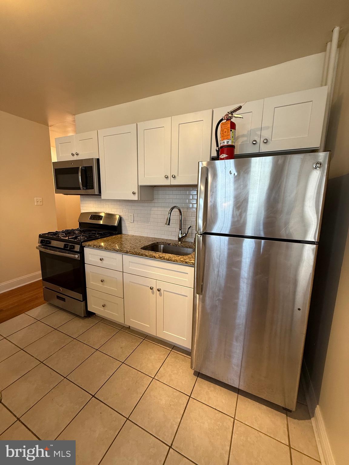 2250 Bryn Mawr Avenue, Unit 1C Philadelphia, PA 19131 - Photo 8 of 12 a kitchen with a refrigerator and a sink