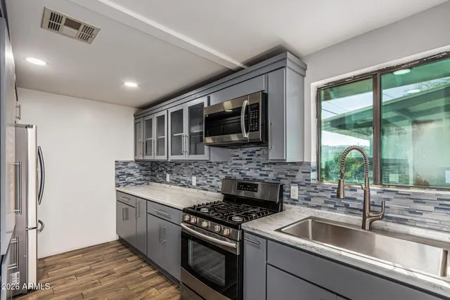 a kitchen with a stove and a sink