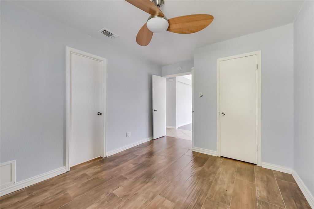509 Parkway Boulevard Coppell, TX 75019 - Photo 10 of 19 a view of an empty room with wooden floor and a chandelier fan