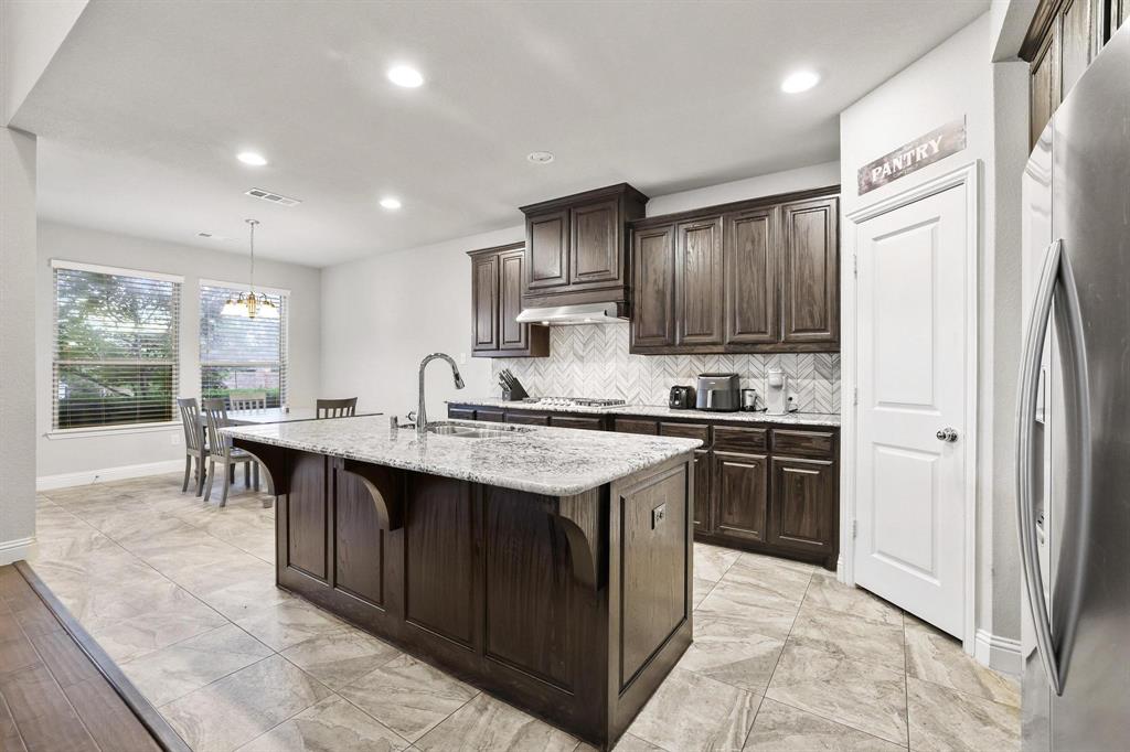 3500 Jersey Road Melissa, TX 75454 - Photo 8 of 40 a kitchen with stainless steel appliances granite countertop a sink stove and refrigerator