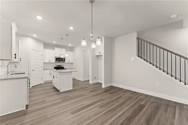 a open kitchen with white cabinets stainless steel appliances