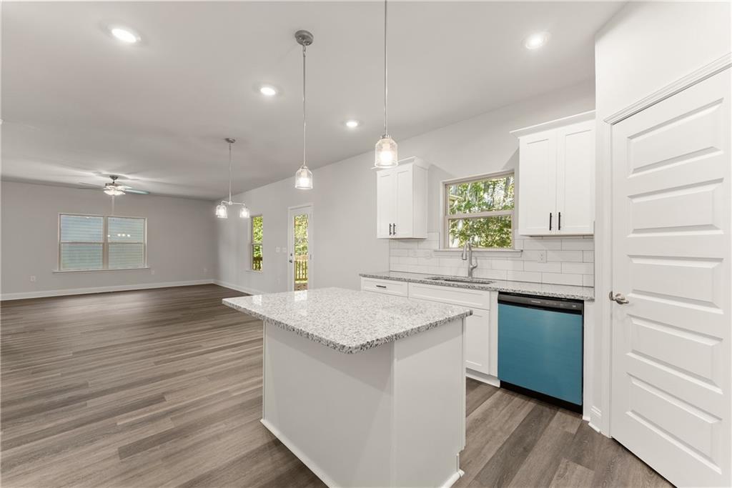 490 Magnolia Grove Place Cornelia, GA 30531 - Photo 15 of 43 a kitchen with granite countertop white cabinets and white appliances
