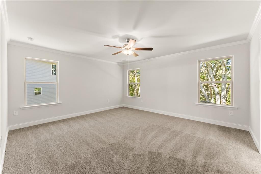 490 Magnolia Grove Place Cornelia, GA 30531 - Photo 33 of 43 an empty room with windows and chandelier fan