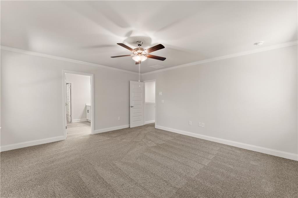 490 Magnolia Grove Place Cornelia, GA 30531 - Photo 35 of 43 an empty room with chandelier fan and windows