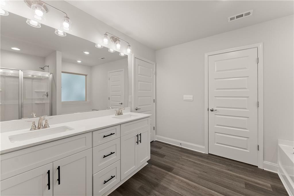 490 Magnolia Grove Place Cornelia, GA 30531 - Photo 38 of 43 a bathroom with a double vanity sink and a mirror