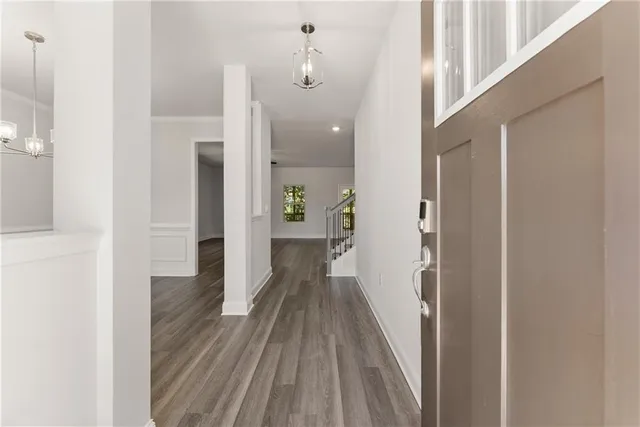 a view of a hallway with wooden floor