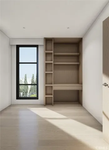 a view of a room with a large window and front door