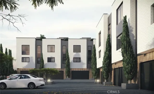 a front view of a residential apartment building with a yard