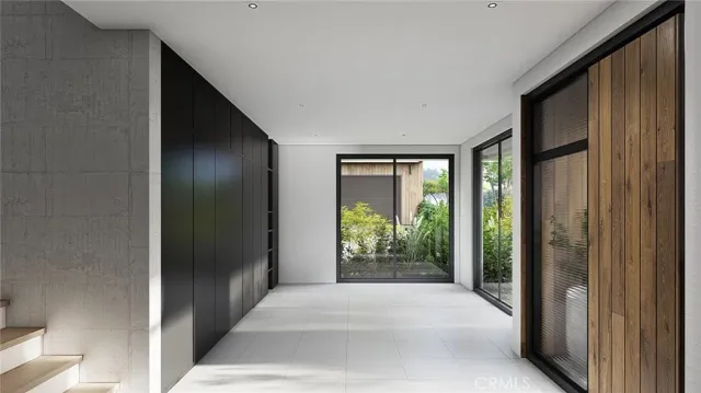 a living room with a large window and doors