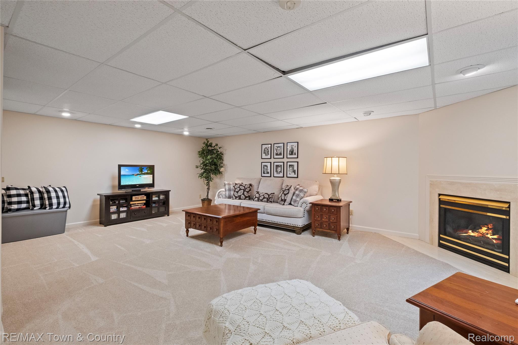 5464 North Seymour Road Flushing, MI 48433 - Photo 32 of 45 Recessed lighting, drop ceiling, wall-mounted fireplace with mantel, and light-toned carpeting