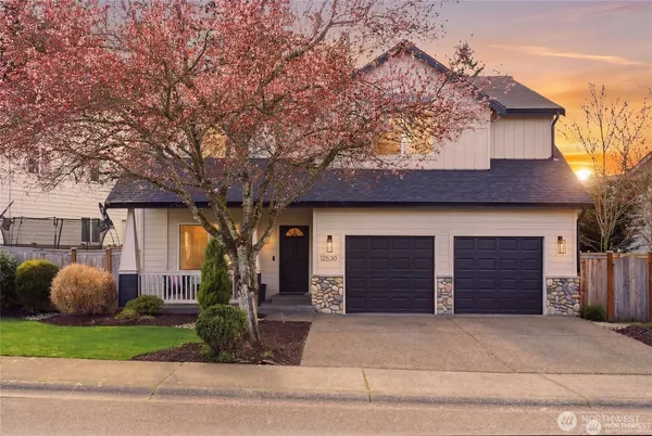 a front view of a house with a yard and garage