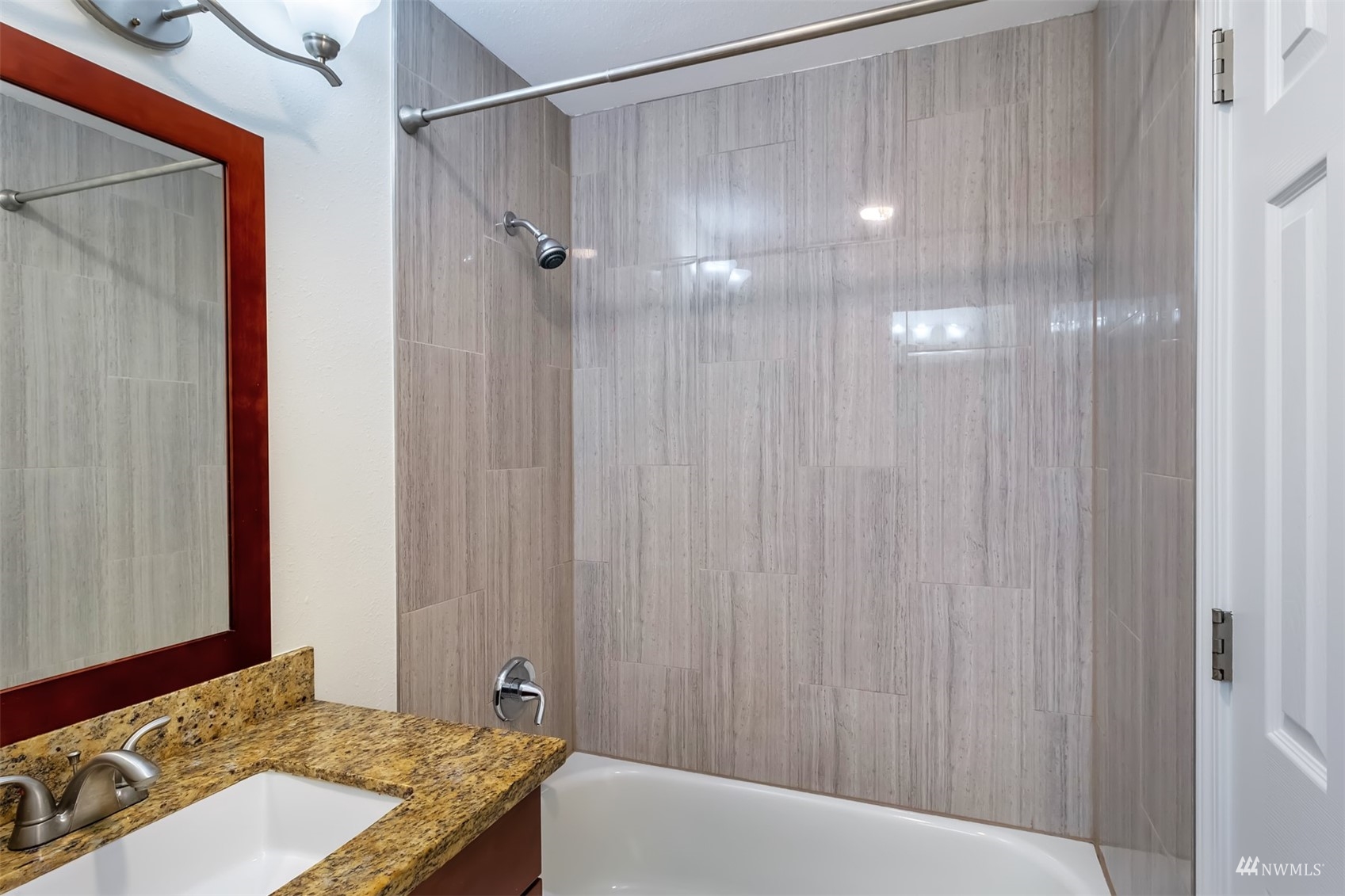 11201 3rd Avenue Southeast, Unit 1B Everett, WA 98208 - Photo 14 of 15 a bathroom with a granite countertop sink and shower
