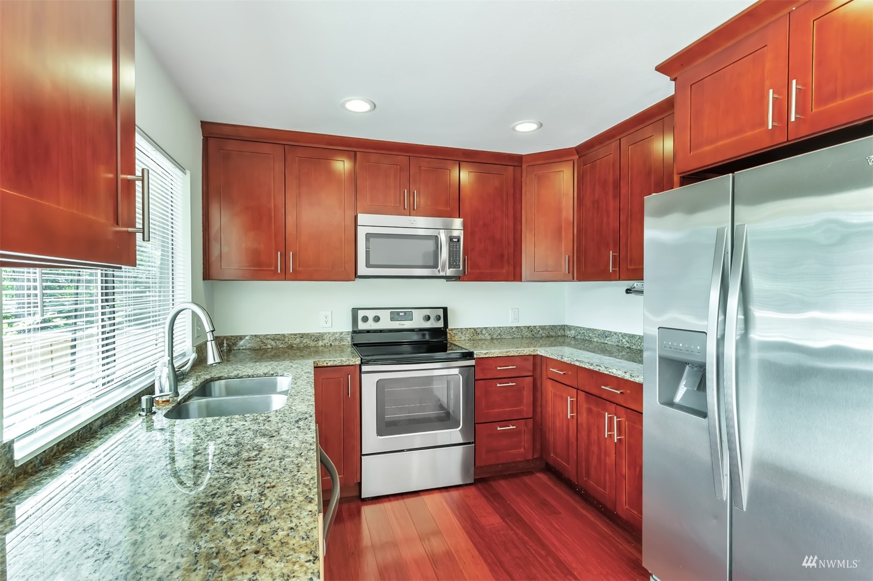 11201 3rd Avenue Southeast, Unit 1B Everett, WA 98208 - Photo 2 of 15 a kitchen with stainless steel appliances granite countertop wooden cabinets a sink and a stove
