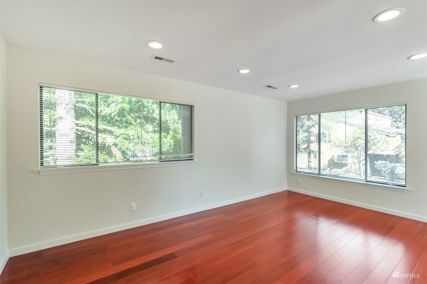 11201 3rd Avenue Southeast, Unit 1B Everett, WA 98208 - Photo 6 of 15 a view of an empty room with wooden floor and a window