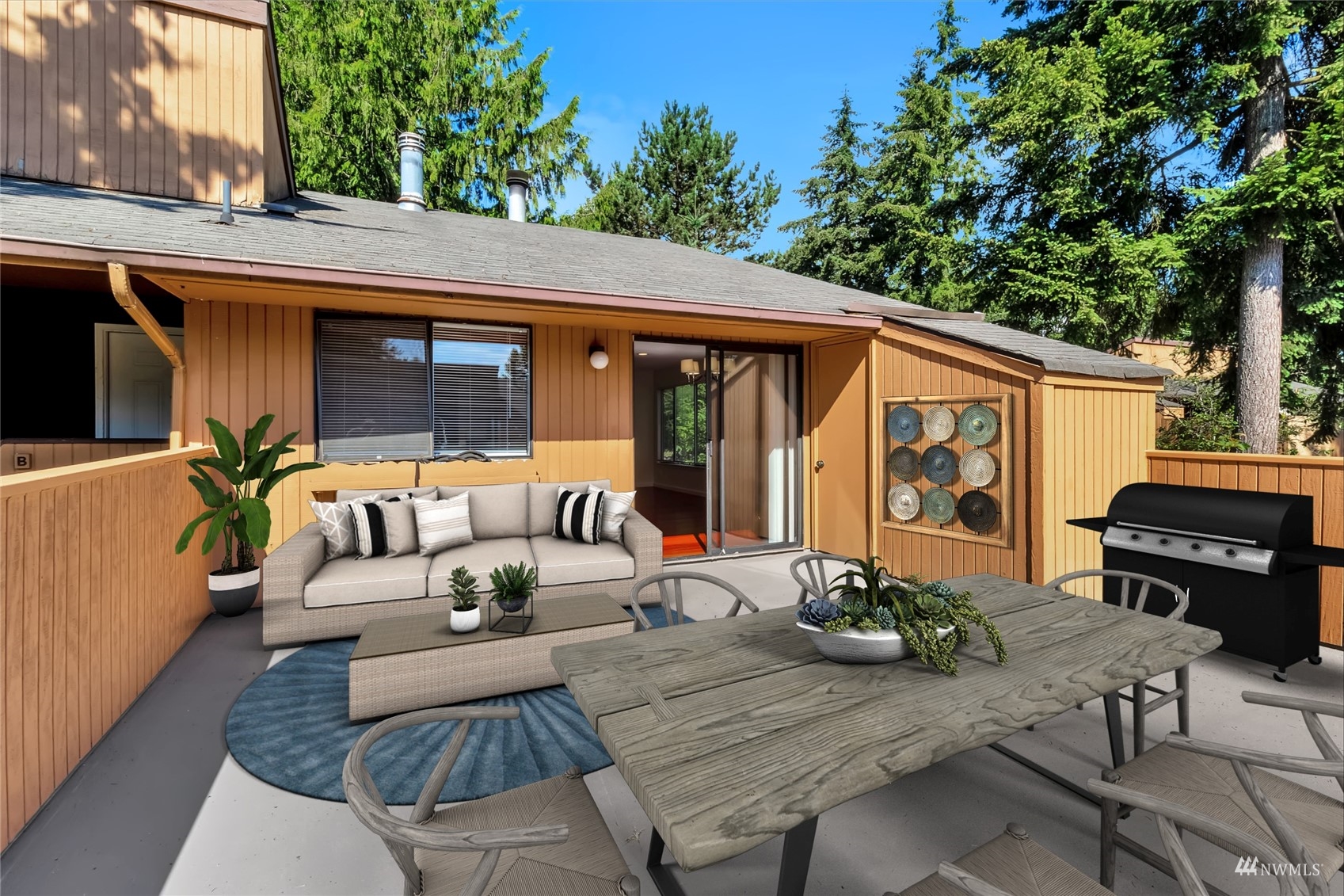 11201 3rd Avenue Southeast, Unit 1B Everett, WA 98208 - Photo 7 of 15 a view of a patio with couches table and chairs with wooden floor and fence