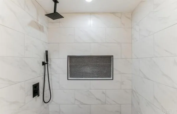 a bathroom with a shower and a shower