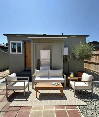 a swimming pool with outdoor seating and a couch