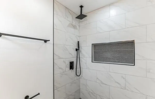 a bathroom with a shower and mirror