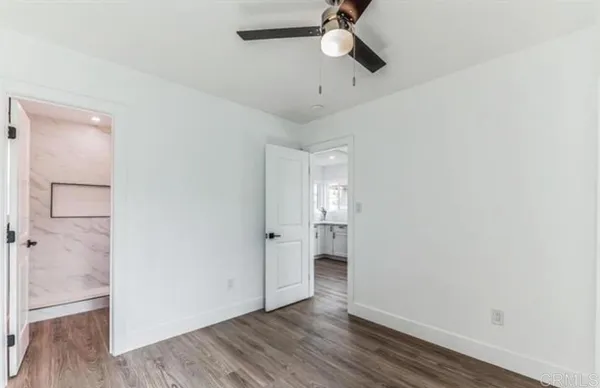 a view of an empty room and wooden floor