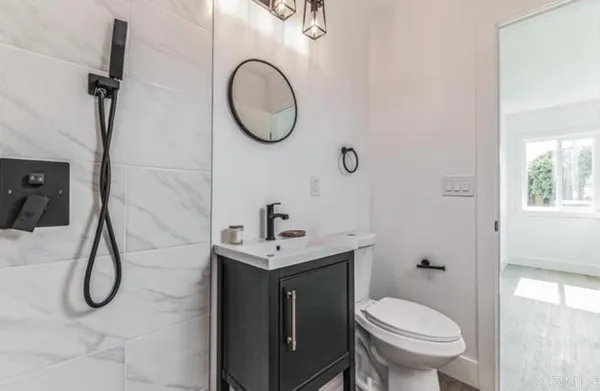 a bathroom with a sink toilet and a mirror