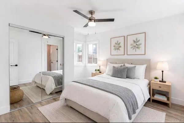 a spacious bedroom with a bed and ceiling fan