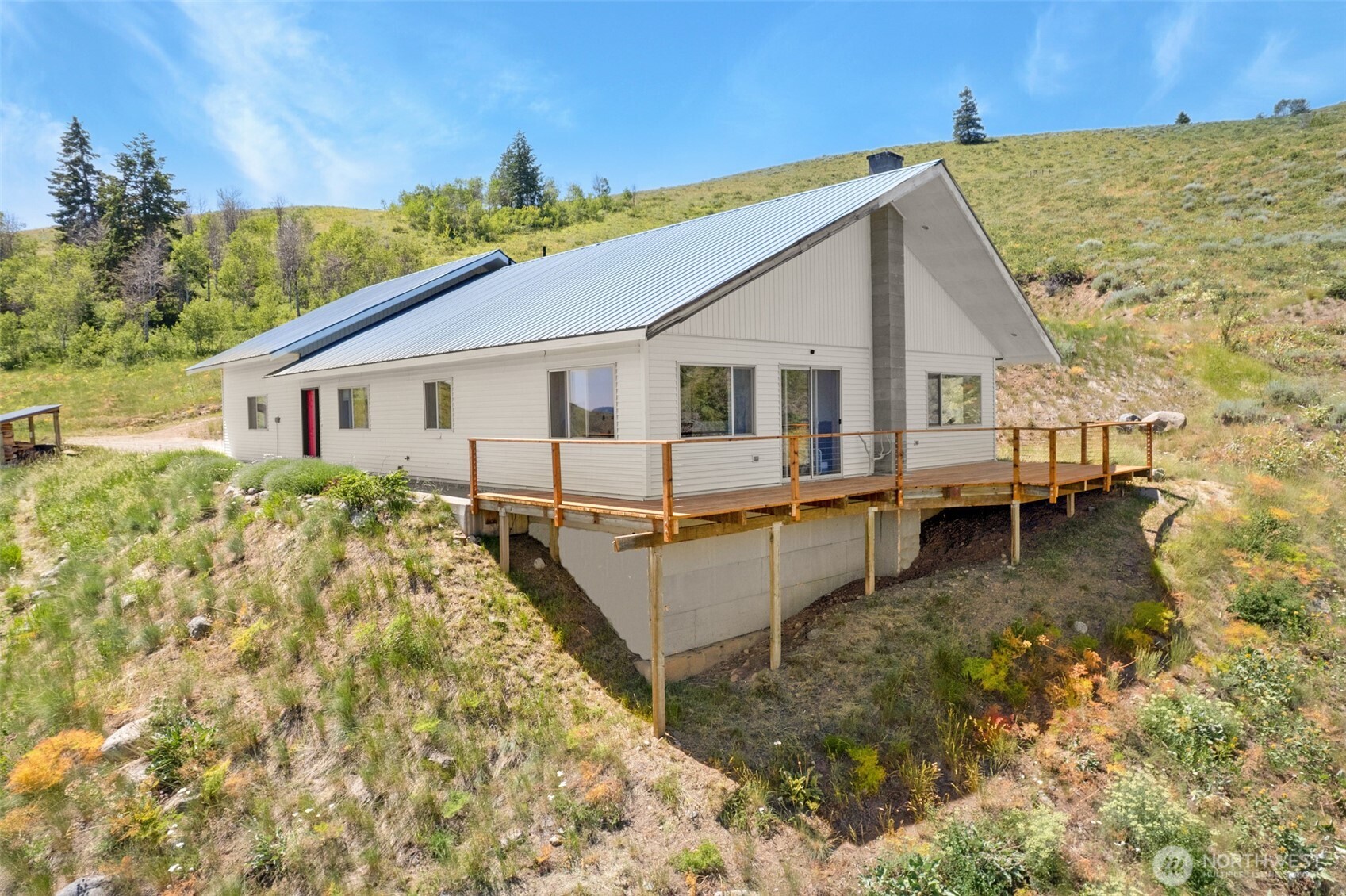 427 Rendezvous Road Winthrop, WA 98862 - Photo 1 of 40 a view of a house with pool and sitting area