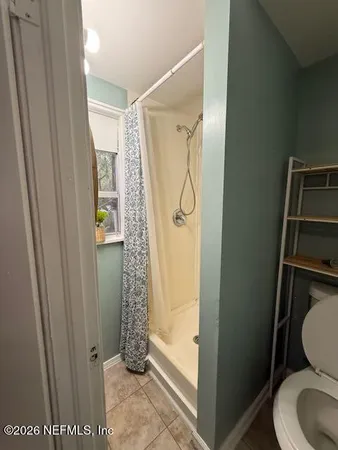 a bathroom with a shower and toilet