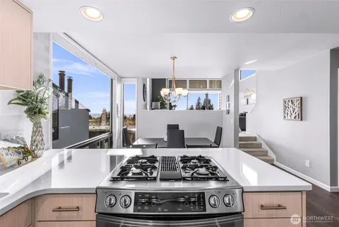 a kitchen with stainless steel appliances granite countertop a refrigerator stove and sink