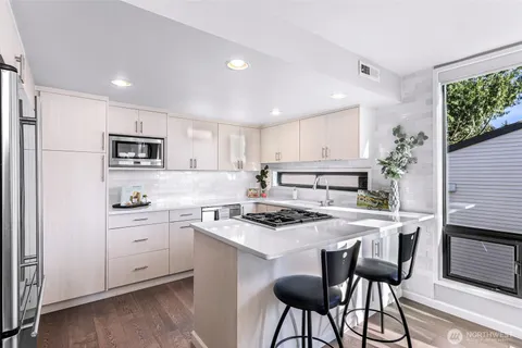 a kitchen with stainless steel appliances a refrigerator and a stove