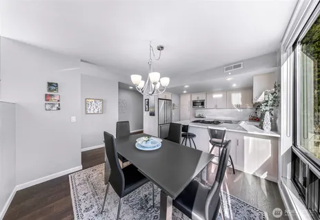 a view of a dining room with furniture and wooden floor