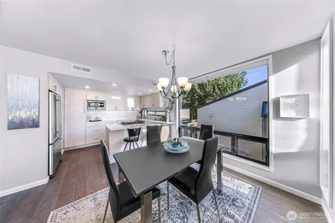 a view of a hallway with wooden floor and windows