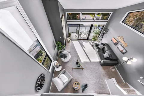 a bedroom with a bed a large window and furniture