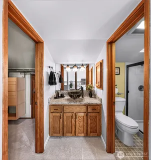 a white toilet sitting next to a bathroom sink and tub