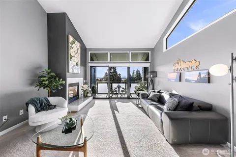 a living room with a fireplace and a floor to ceiling window