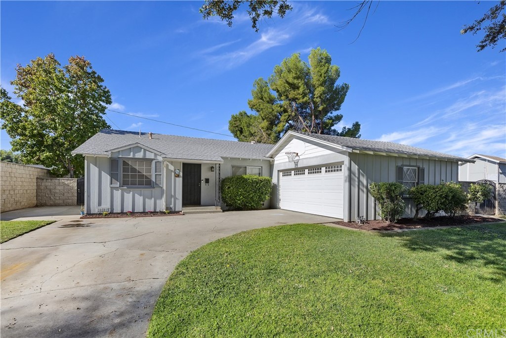 2994 Molly Street Riverside, CA 92506 - Photo 1 of 1 a front view of a house with a garden and yard