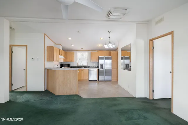 a view of an empty room with window and cabinet