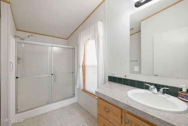 a bathroom with a sink and mirror with toilet