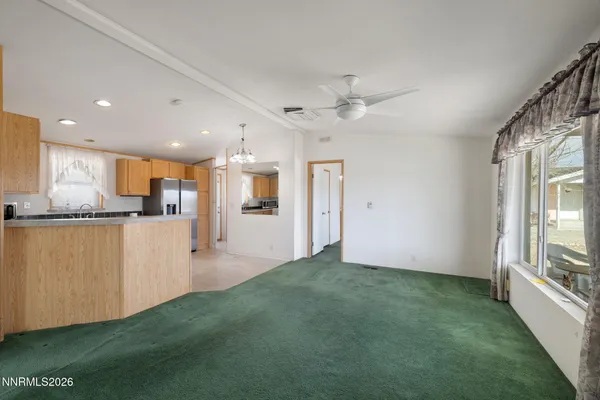 a view of a kitchen with kitchen island wooden floor center island and stainless steel appliances