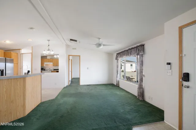 a view of a big room with closet and windows