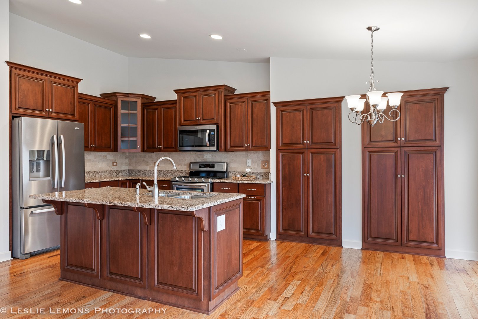 1940 Baldwin Way Bolingbrook, IL 60490 - Photo 5 of 28 a kitchen with stainless steel appliances granite countertop a refrigerator a sink dishwasher a stove with wooden cabinets and floor